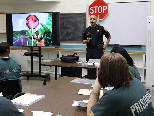 deputy providing instruction to inmates on traffic flagging