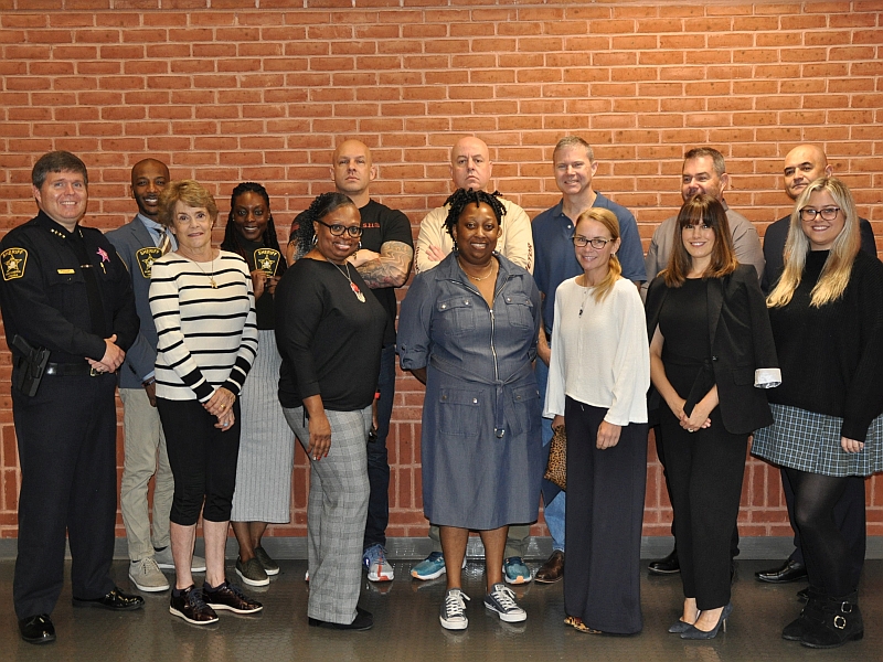 Sheriff standing with 13 Alexandrians who participated in community academy