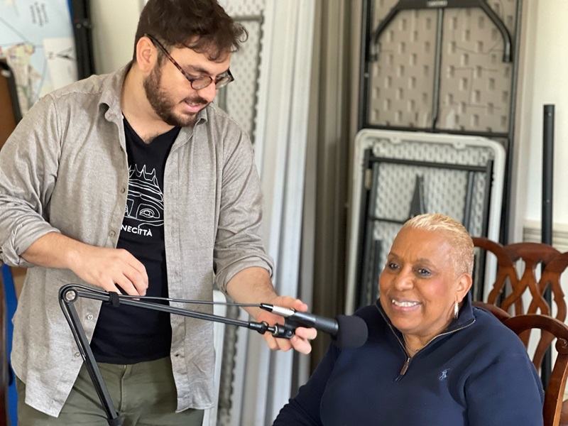 Francesco with microphone, interviewing Verdella Jennings