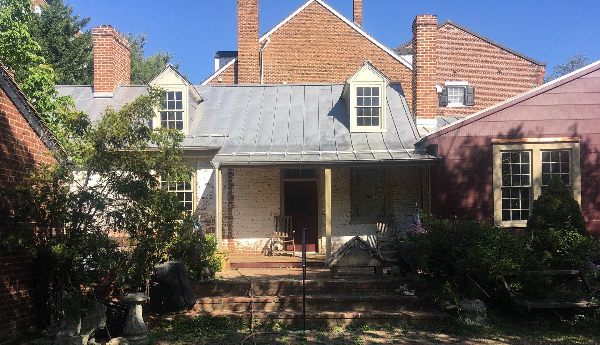 West side, after renovation, with porch and red-painted wall