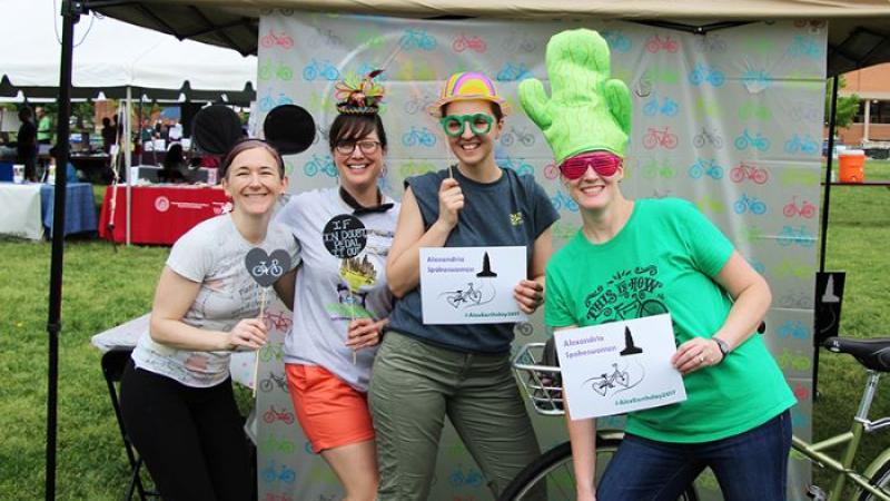 A photo of members of the Alexandria Spokeswomen bicycle group at Alexandria Earth Day