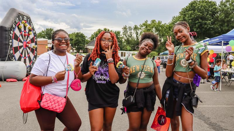 Four teen girls smiling and posing