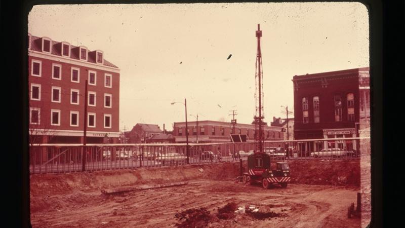 Urban renewal construction site with artifacts visible.