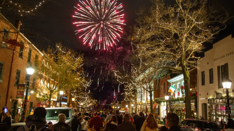 people on king street at night looking at fireworks