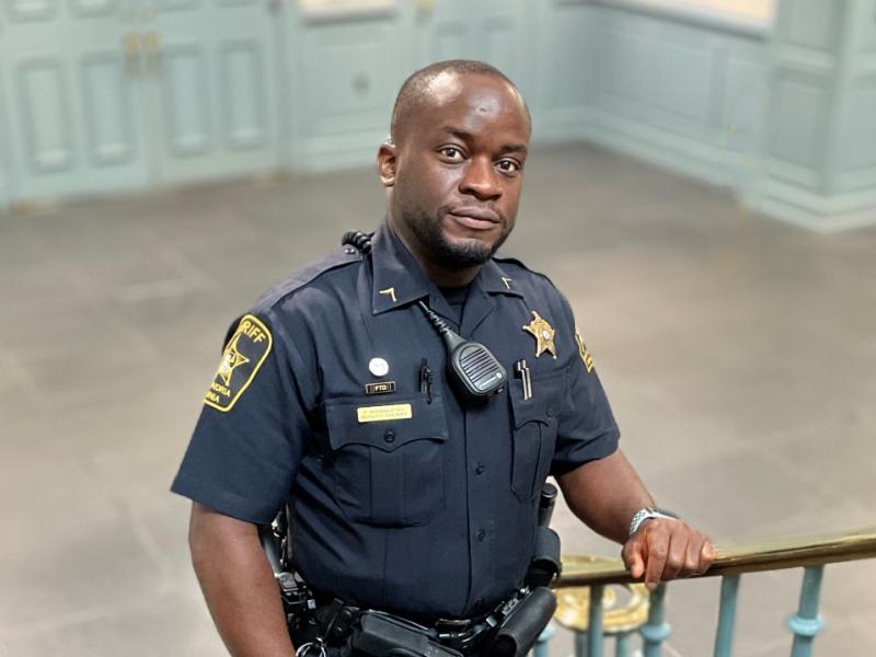 deputy in blue uniform on duty in the courthouse lobby