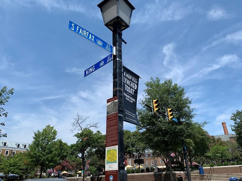 Thomas historic marker and banner reading A Man was Lynched Here (2021)