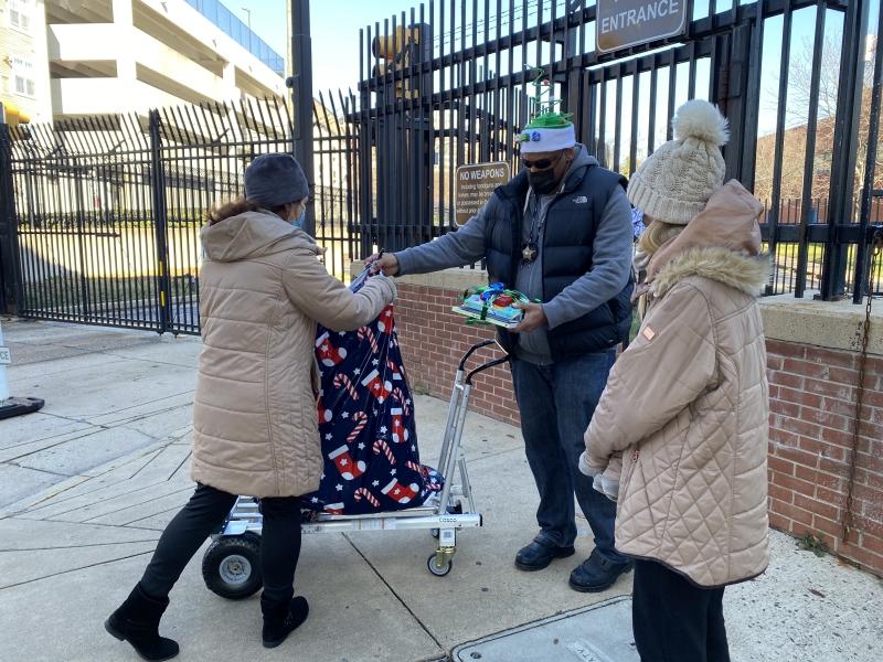 family picks up wrapped gifts from a deputy