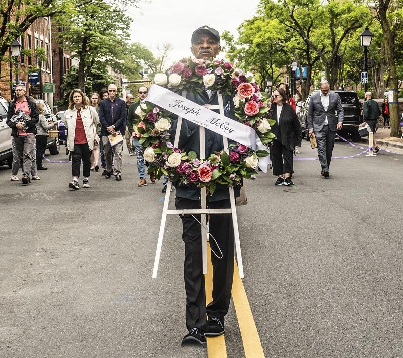 McCoy 2023 carrying wreath. 