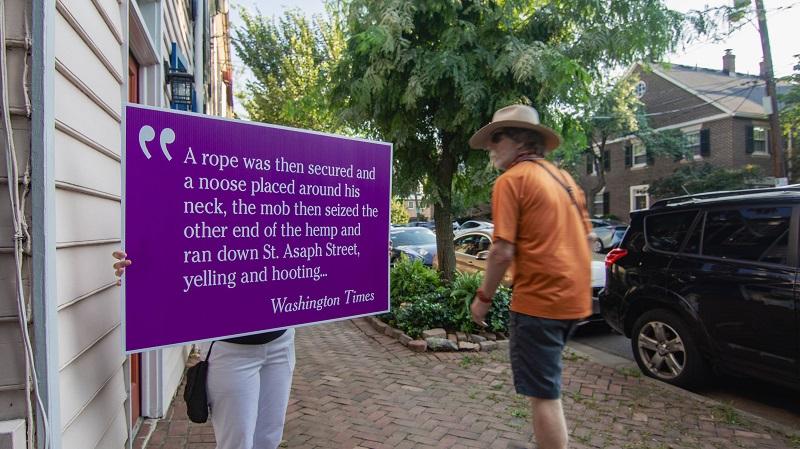 sign with quote carried in procession