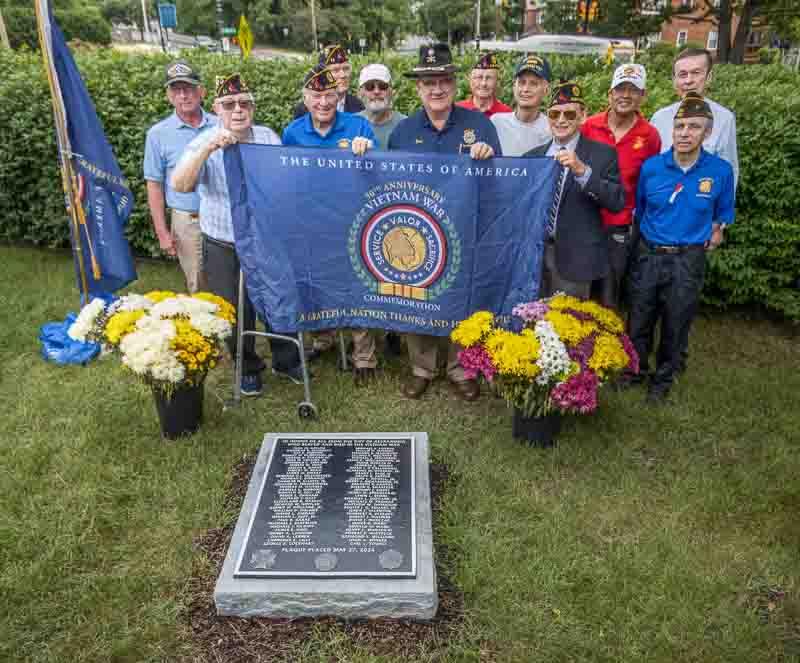 VFW members with plaque and banner