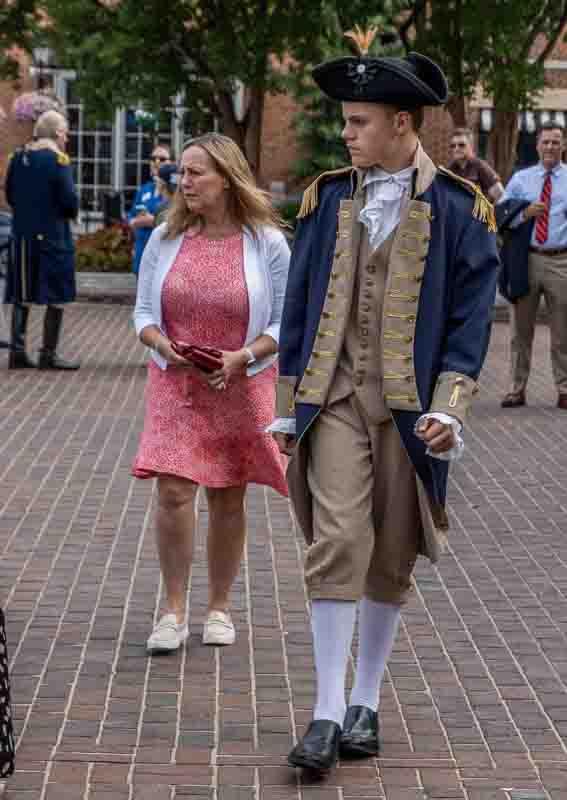 Man in colonial dress and woman walking on Market Square