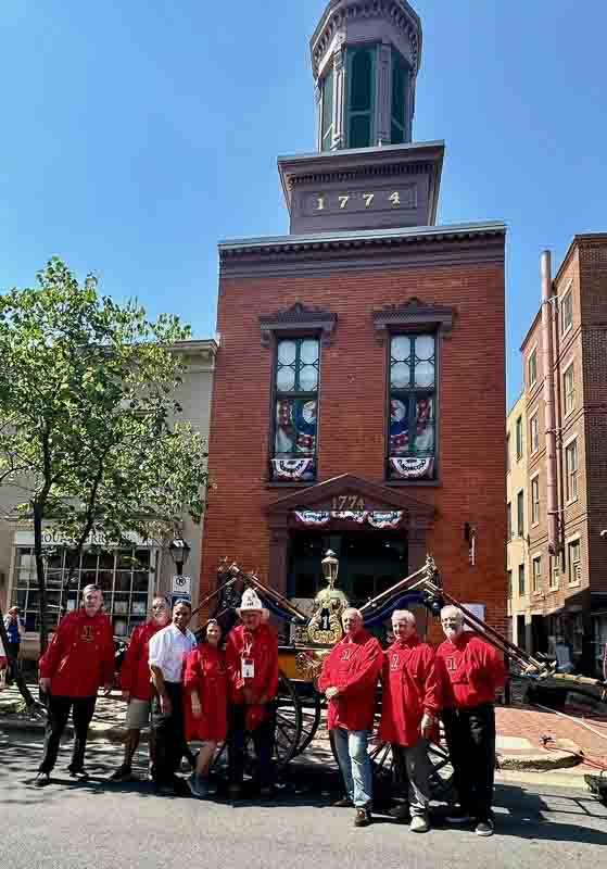 FVFEA group with Rodgers Suction Engine, outside of the Friendship Firehouse