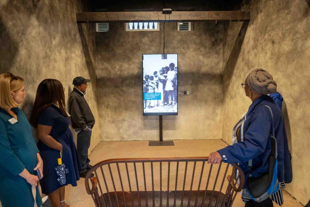 visitors with exhibit in basement