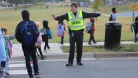 sheriff directing traffic with kids in crosswalk