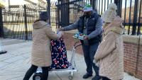 family picks up wrapped gifts from a deputy