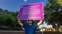 sign with quote carried in procession