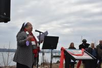 Audrey Davis speaking and sign with ribbon