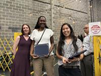 An MRC Volunteer smiles with her certificate