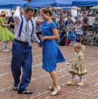 Swing dancers and child