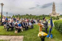 Mayor Justin Wilson at podium, with audience and Masonic Memorial