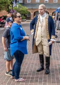 Man in colonial dress talking to people on Market Square