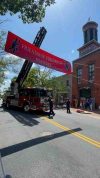 Banner hoisted by ladder truck