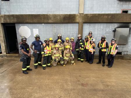 Spring 2023 Community Fire Academy participants pose for a group shot after a day of hands-on sessions with a few of first responders.