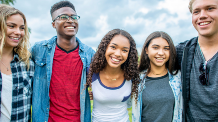 group of teens gathered and smiling at camera