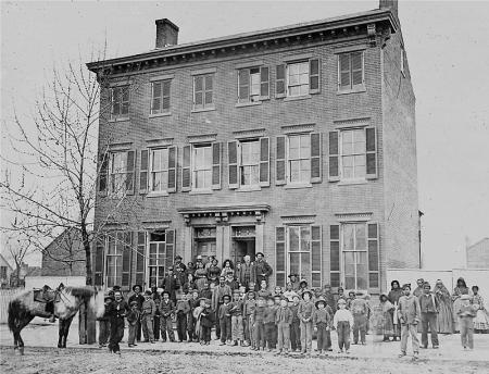 three story double house with people standing outside