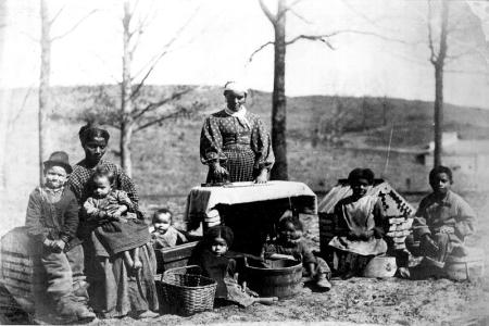 Wassherwoman and children outdoors