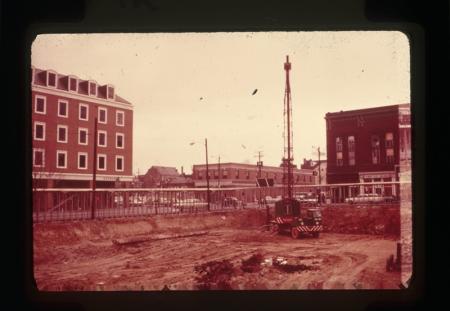 Urban renewal construction site with artifacts visible.