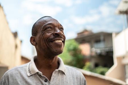 Hopeful man looking up and smiling