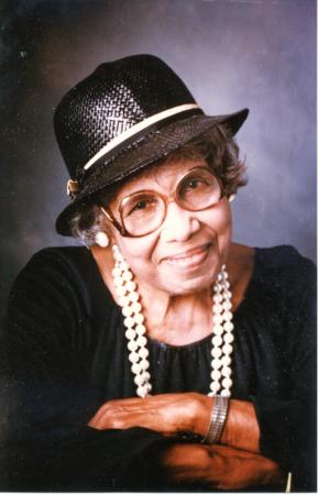 Portrait of Annie B. Rose, in black hat and pearls