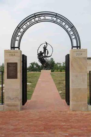 Entrance gate with statue at end of path