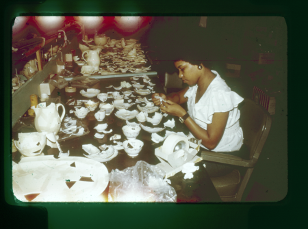 A lab volunteer pieces together ceramics.