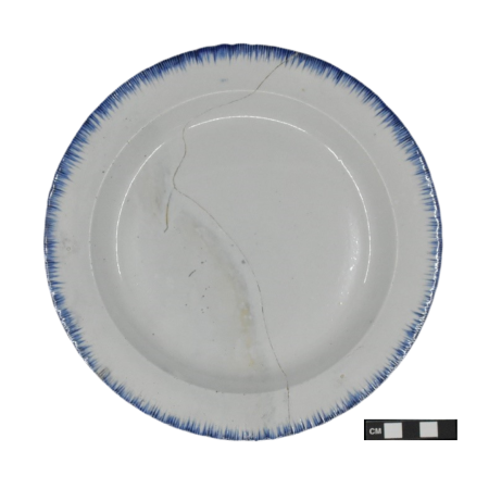 A blue shell-edged plate, approximately 8.5 inches in diameter, with a crack running through the middle. 