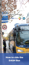 person waiting at bus stop as DASH bus arrives